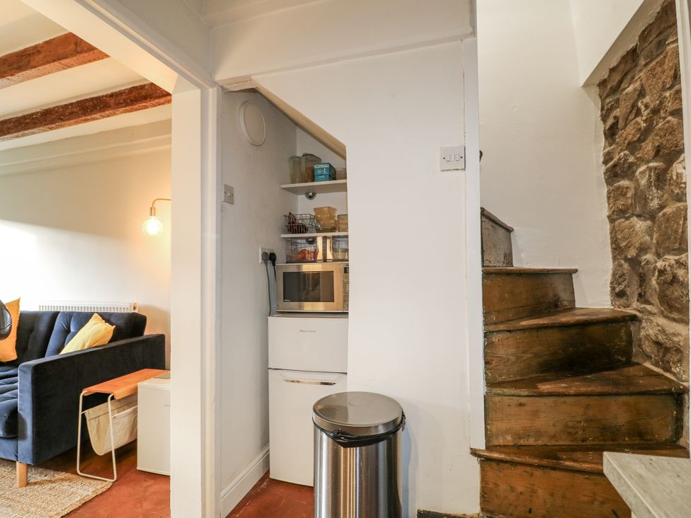 A living room with a sofa and microwave at 5 Belper Lane End, Belper