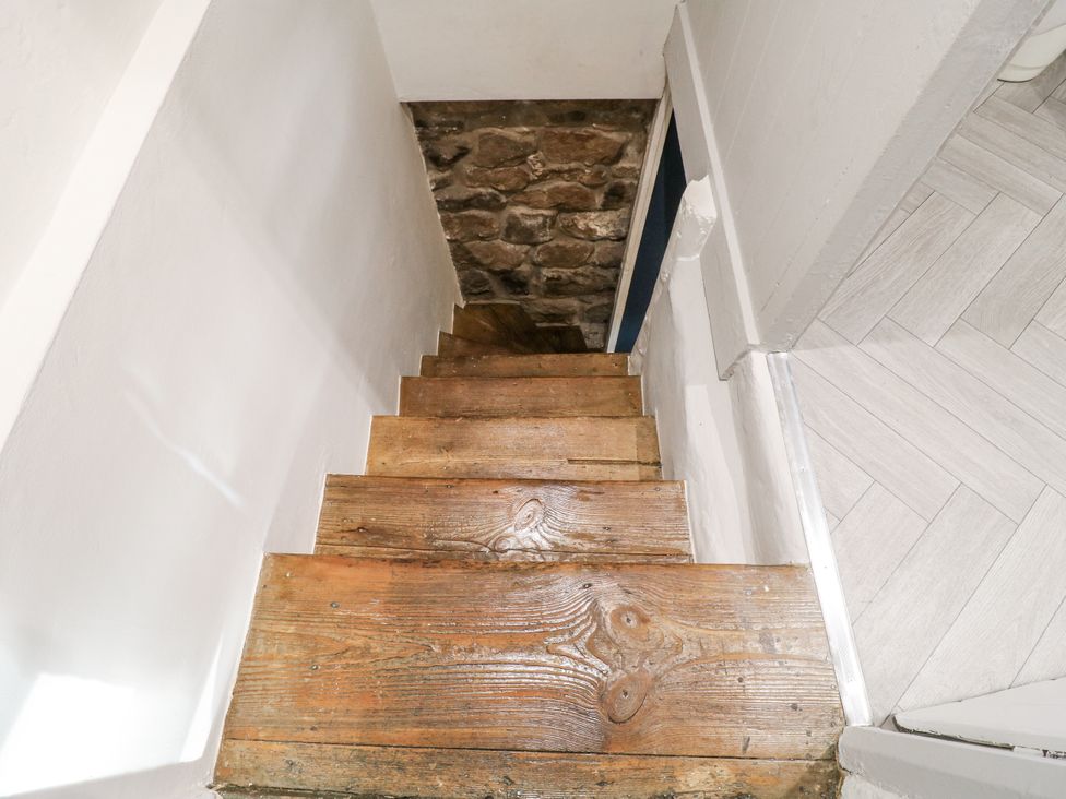 A staircase with wooden stairs leading down at 5 Belper Lane End in Belper
