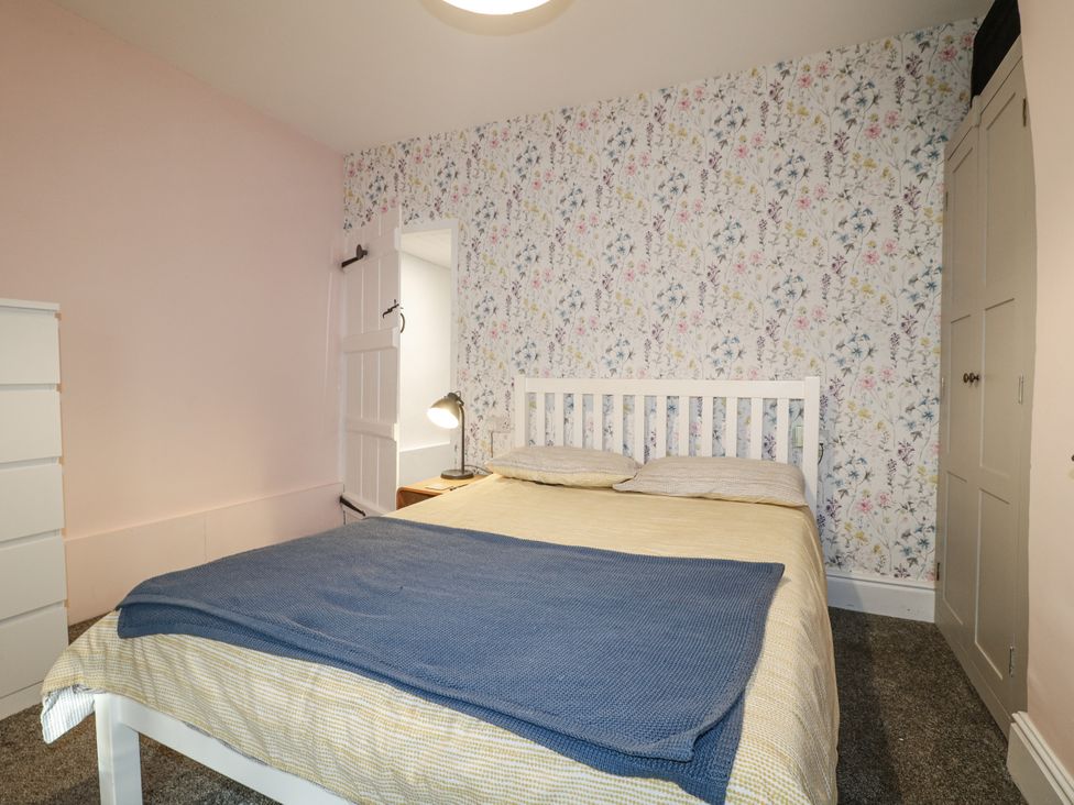 A bedroom with a bed and dresser at 5 Belper Lane End in Belper