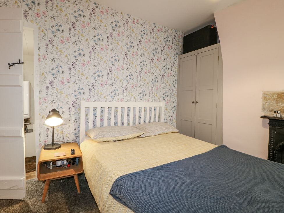 A bedroom with a bed and bedside table at 5 Belper Lane End in Belper