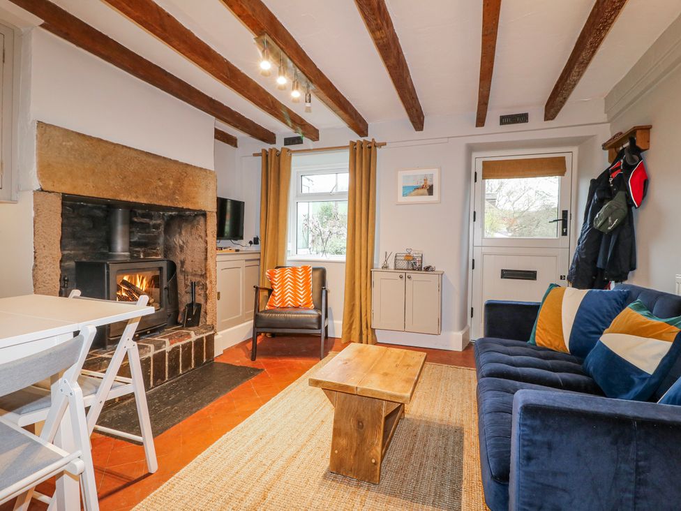 A living room with a fireplace and sofa at 5 Belper Lane End in Belper