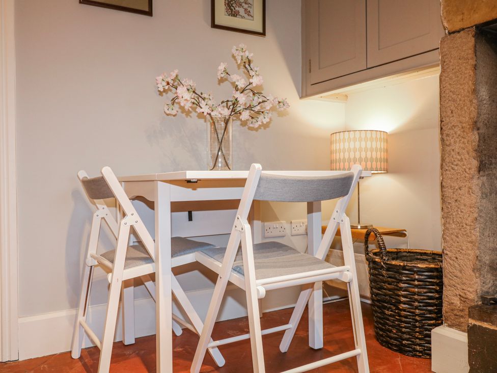 A dining room with a table and chairs at 5 Belper Lane End in Belper