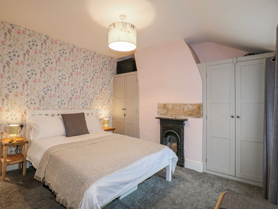 A bedroom with a bed and a wardrobe at 5 Belper Lane End in Belper