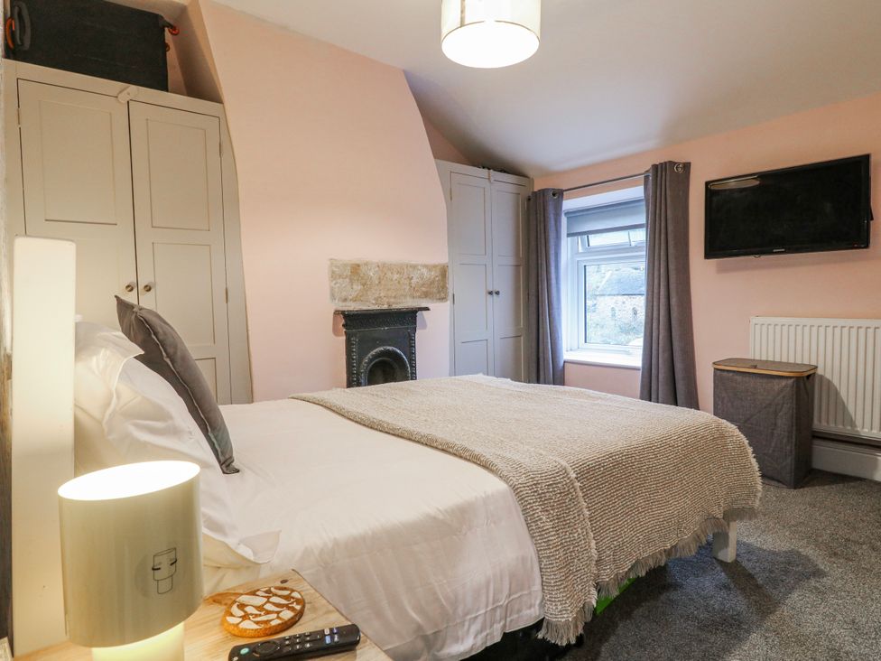 A bedroom with a bed and television at 5 Belper Lane End, Belper