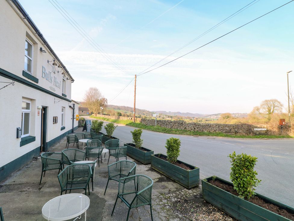 An outdoor seating area with tables and chairs at Bulls Head in Belper