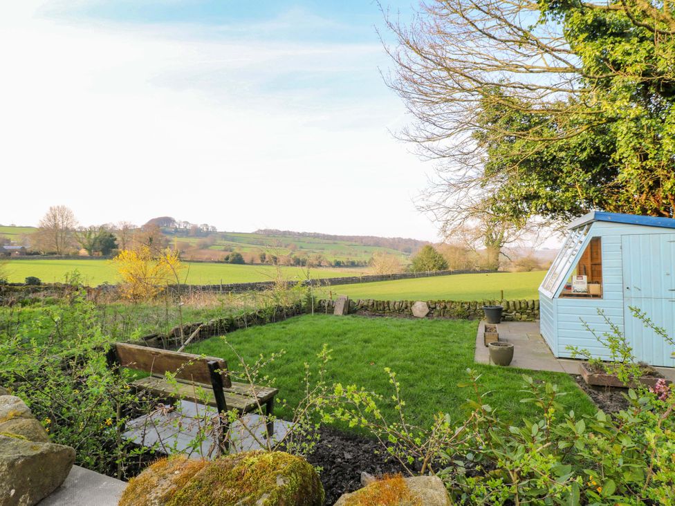 A garden with a bench and a shed at 5 Belper Lane End in Belper