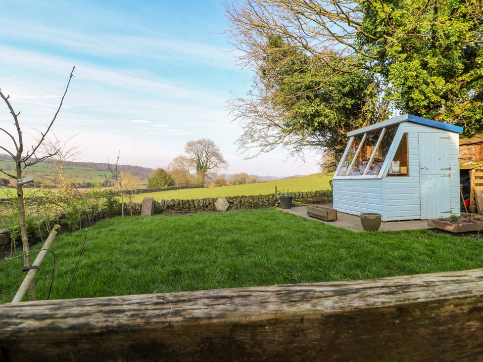 A garden with a shed and grass at 5 Belper Lane End in Belper