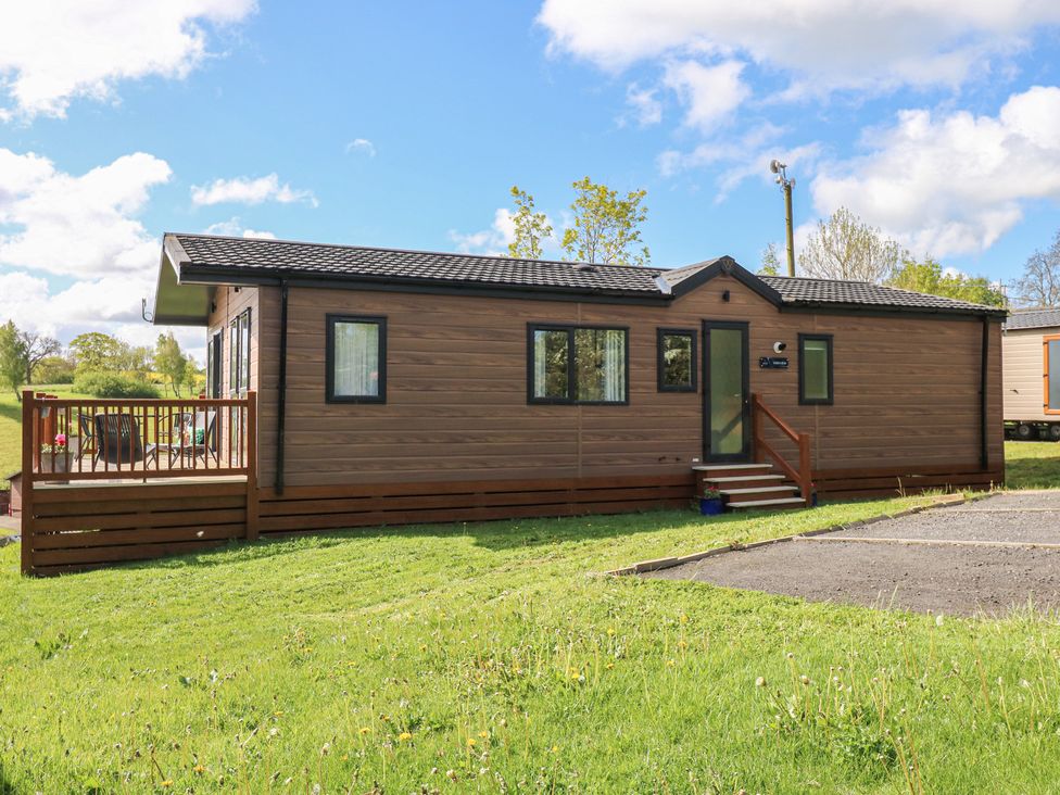 A mobile home with a deck and steps at Lodge 52 in Richmond