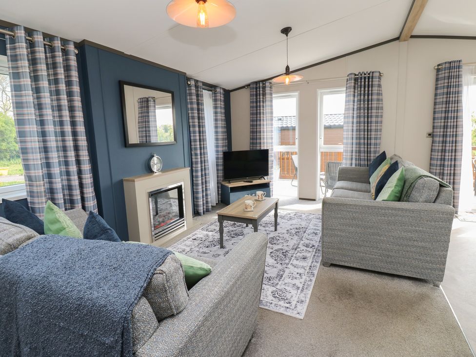 A living room with a sofa and television at Lodge 52 in Richmond