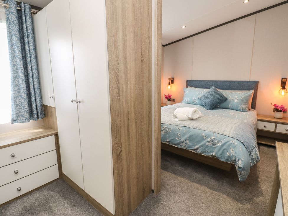 A bedroom with a bed and wardrobe at Lodge 52 in Richmond