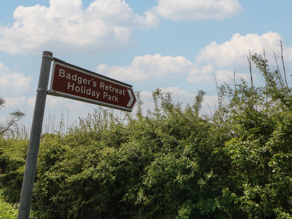 A sign for Badger's Retreat Holiday Park located outdoors in Richmond