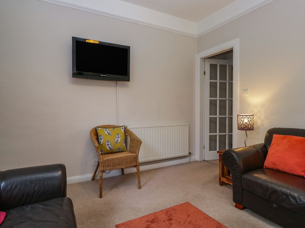 A living room with a television and sofa at Cloud Cottage in Ambleside
