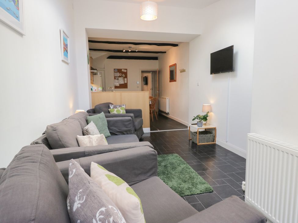 A living room with sofas and a TV at Cloud Cottage in Ambleside