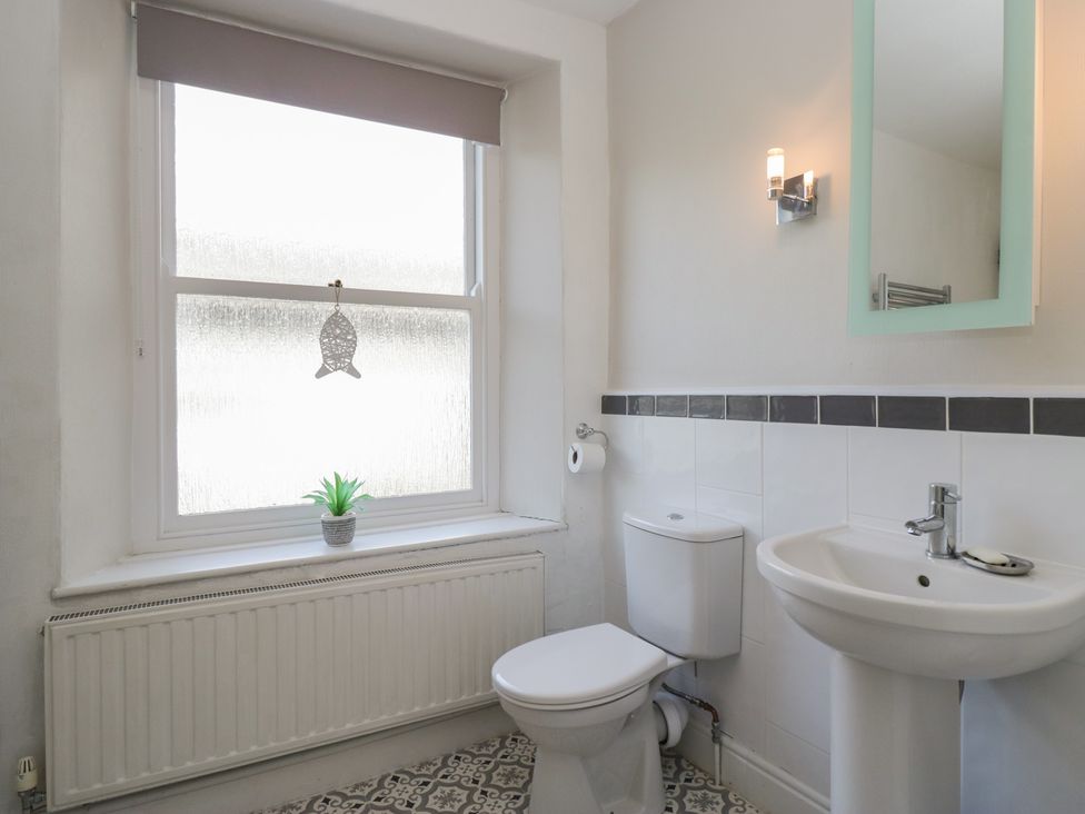 A bathroom with a toilet and sink at Cloud Cottage in Ambleside