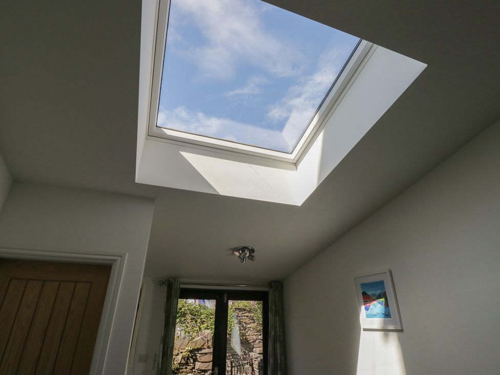 A room with a skylight, window, and door at Cloud Cottage in Ambleside