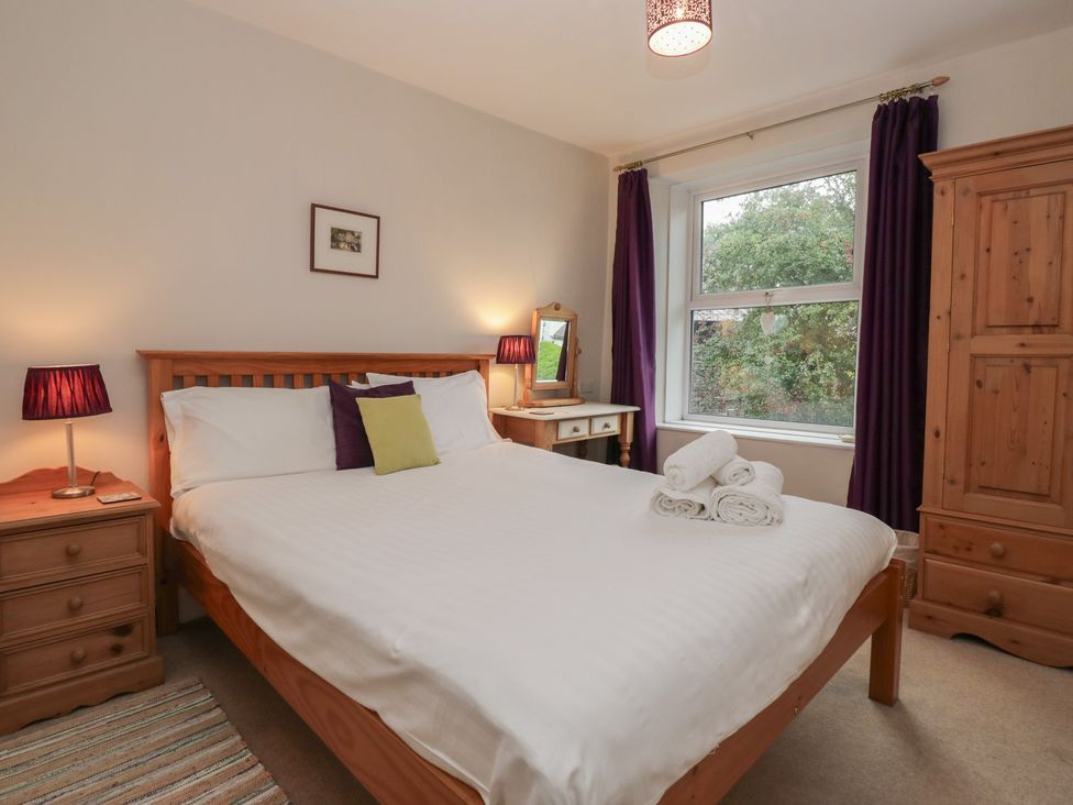 A bedroom with a bed and bedside tables at Cloud Cottage in Ambleside