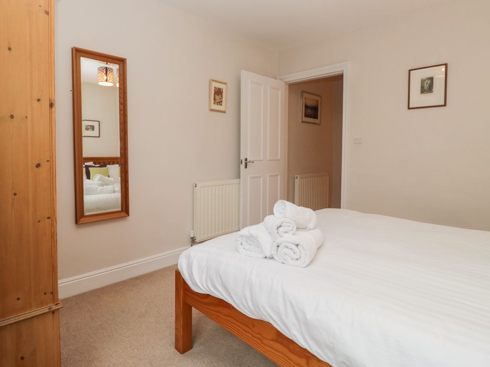 A bedroom with towels on a bed at Cloud Cottage in Ambleside
