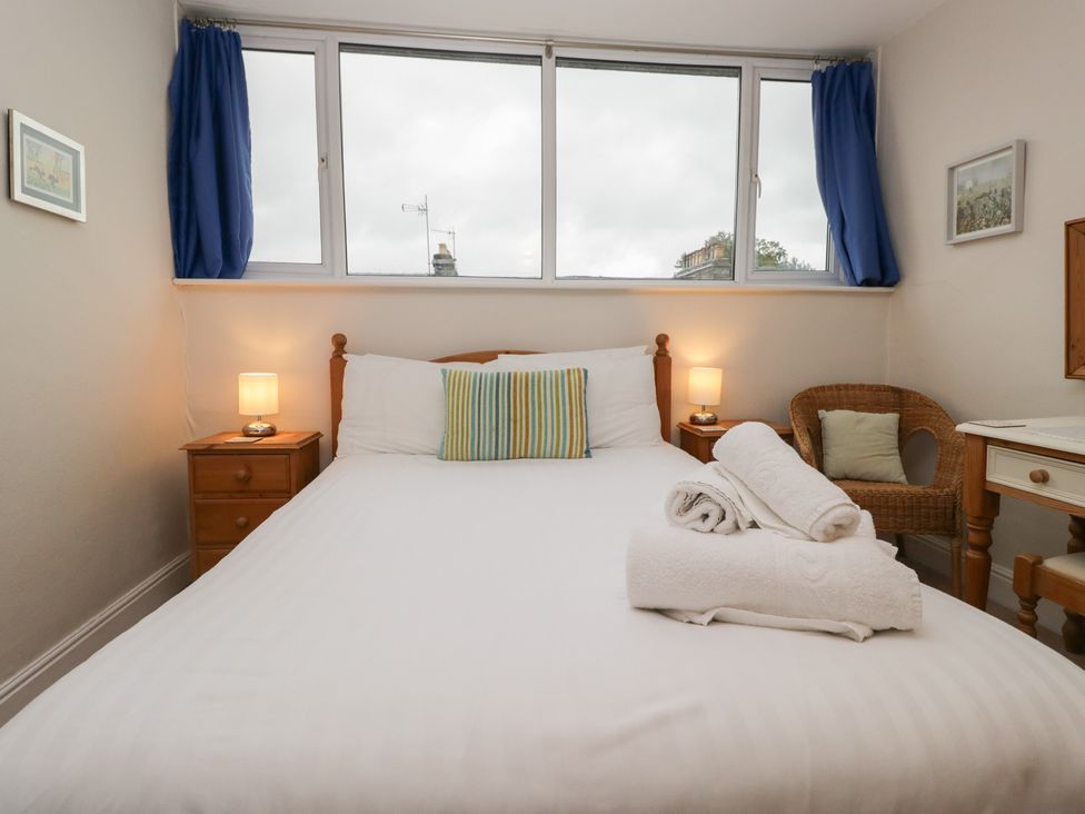 A bedroom with a bed and lamp at Cloud Cottage in Ambleside
