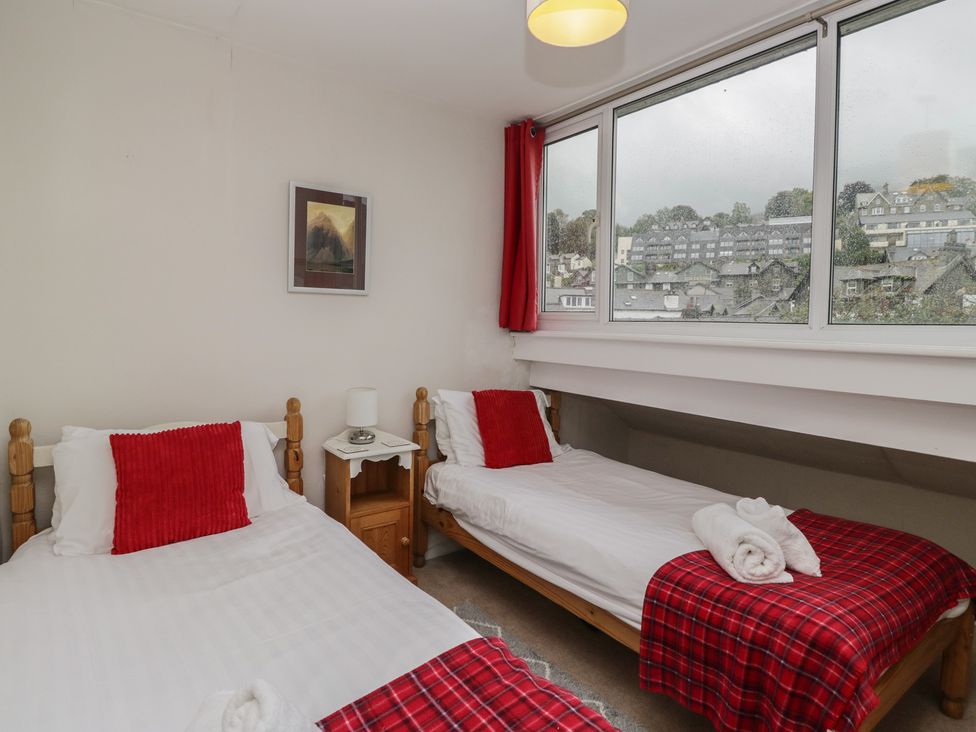 A bedroom with two beds and a window at Cloud Cottage in Ambleside