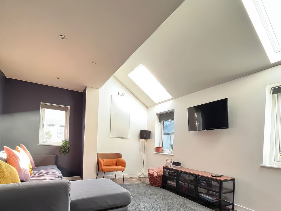 A living room with a sofa and television at Hen Stablau in Dinmael near Cerrigydrudion