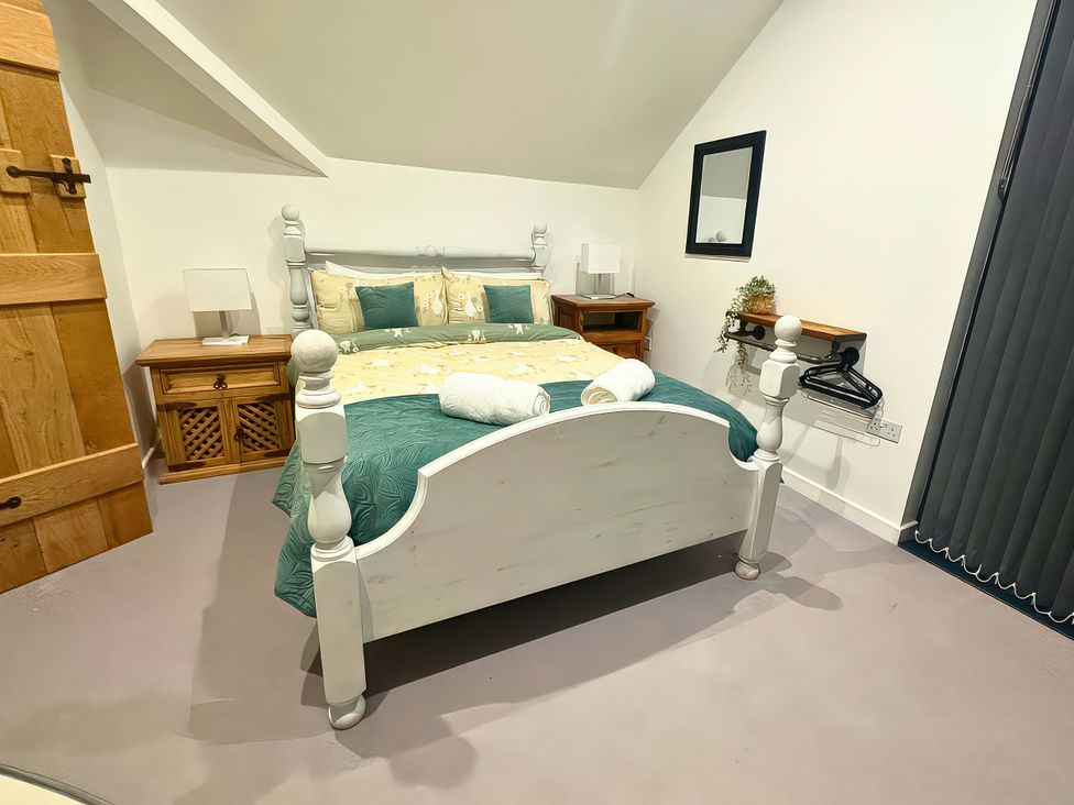 A bedroom with bed and bedside tables at Hen Stablau Dinmael near Cerrigydrudion