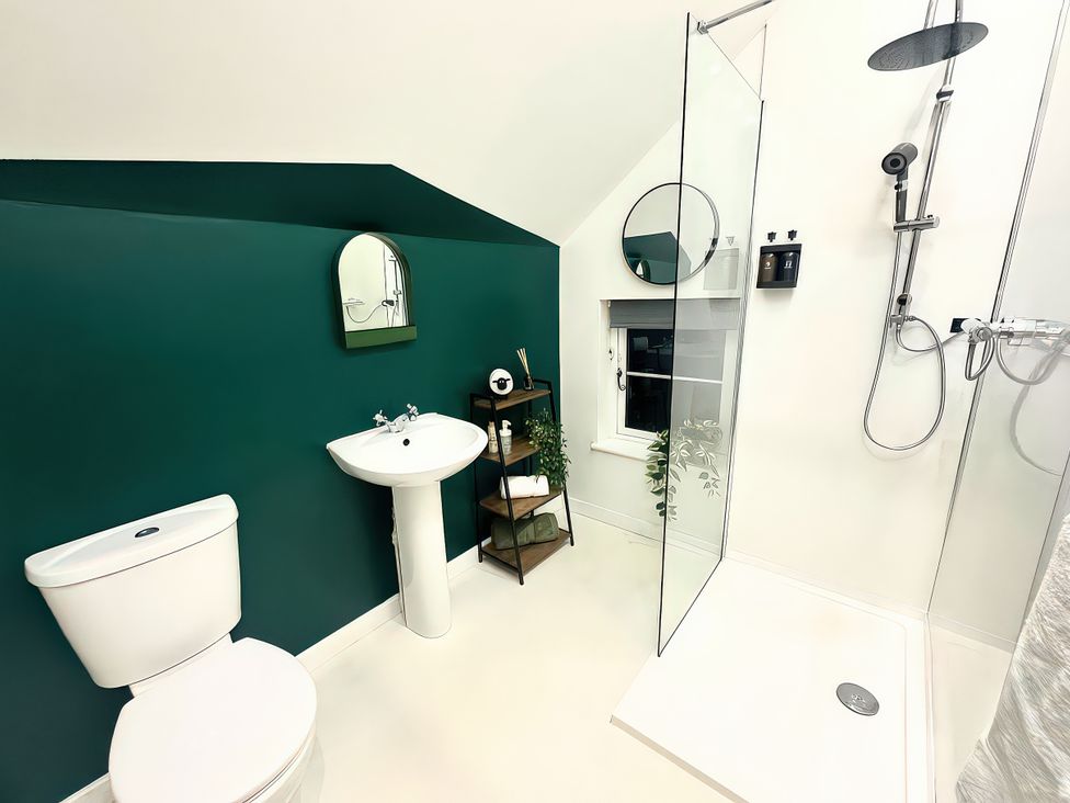A bathroom with a sink and shower at Hen Stablau in Dinmael near Cerrigydrudion