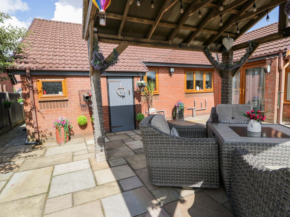 A patio area with seating and planters at Pentre Country Studio near Chirk