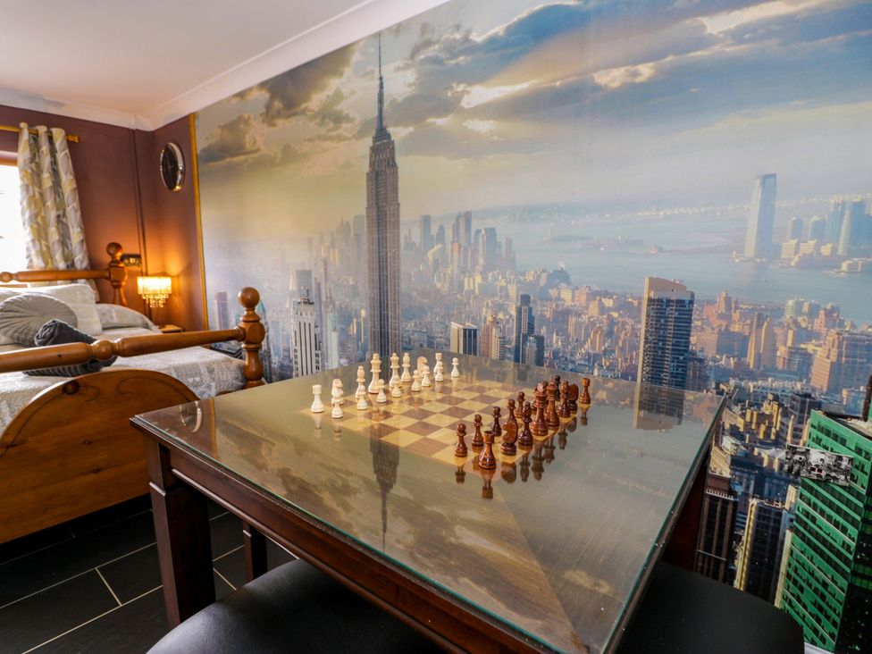 A chess board and bed in a bedroom at Pentre Country Studio near Chirk