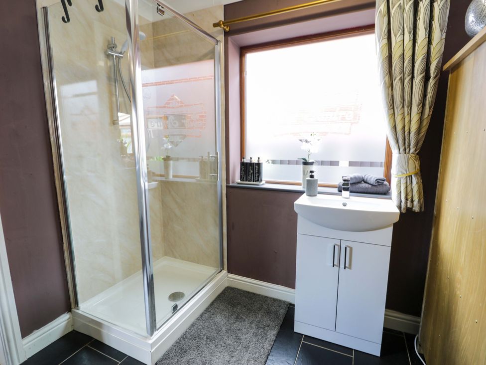 A bathroom with a shower and sink at Pentre Country Studio near Chirk