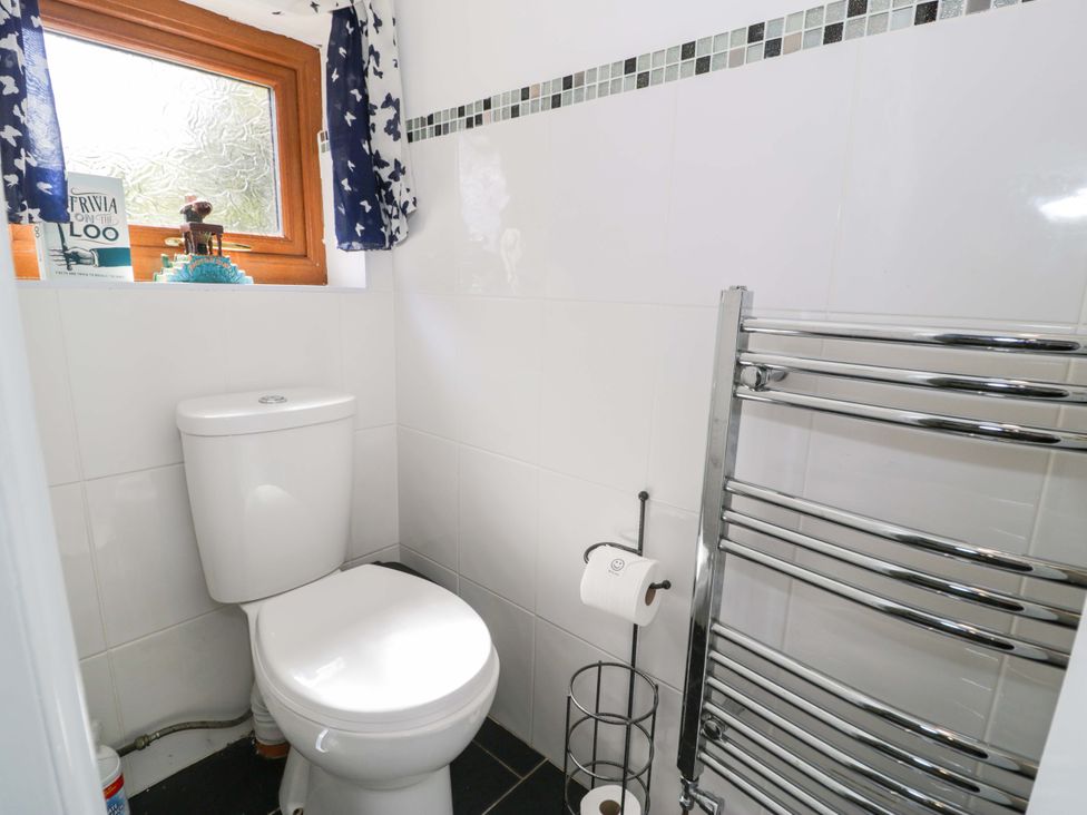A bathroom with a toilet and window at Pentre Country Studio near Chirk