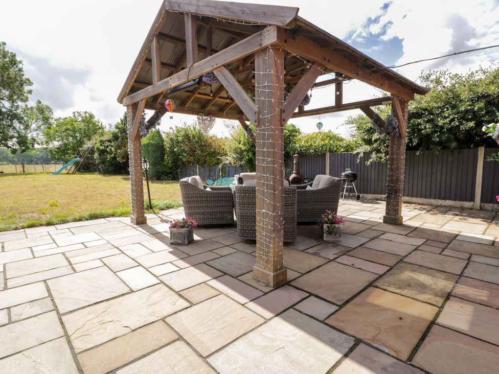 An outdoor seating area under a pergola at Pentre Country Studio near Chirk