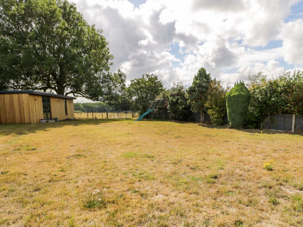 A garden with a slide and a shed at Pentre Country Studio near Chirk