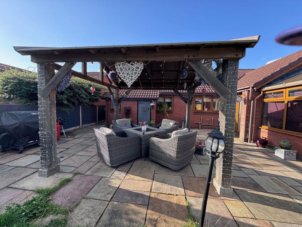 A garden with a seating area and canopy at Pentre Country Studio near Chirk