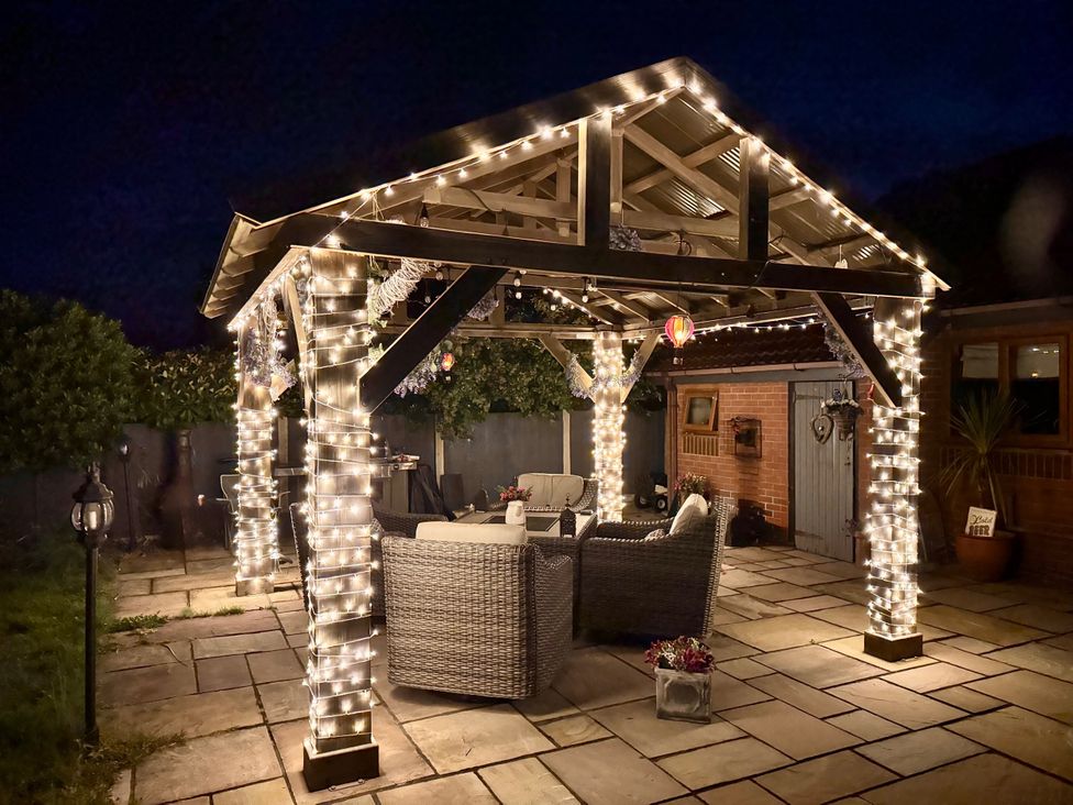 A gazebo with lights and seating at Pentre Country Studio near Chirk