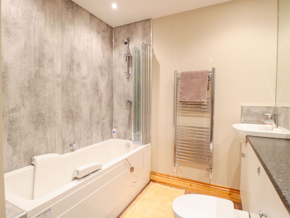 A bathroom with a bathtub and sink at The Old Sorting Office