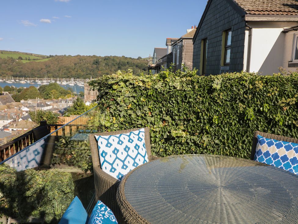 An outdoor area with a table and chairs overlooking a marina at 36 Crowthers Hill in Dartmouth