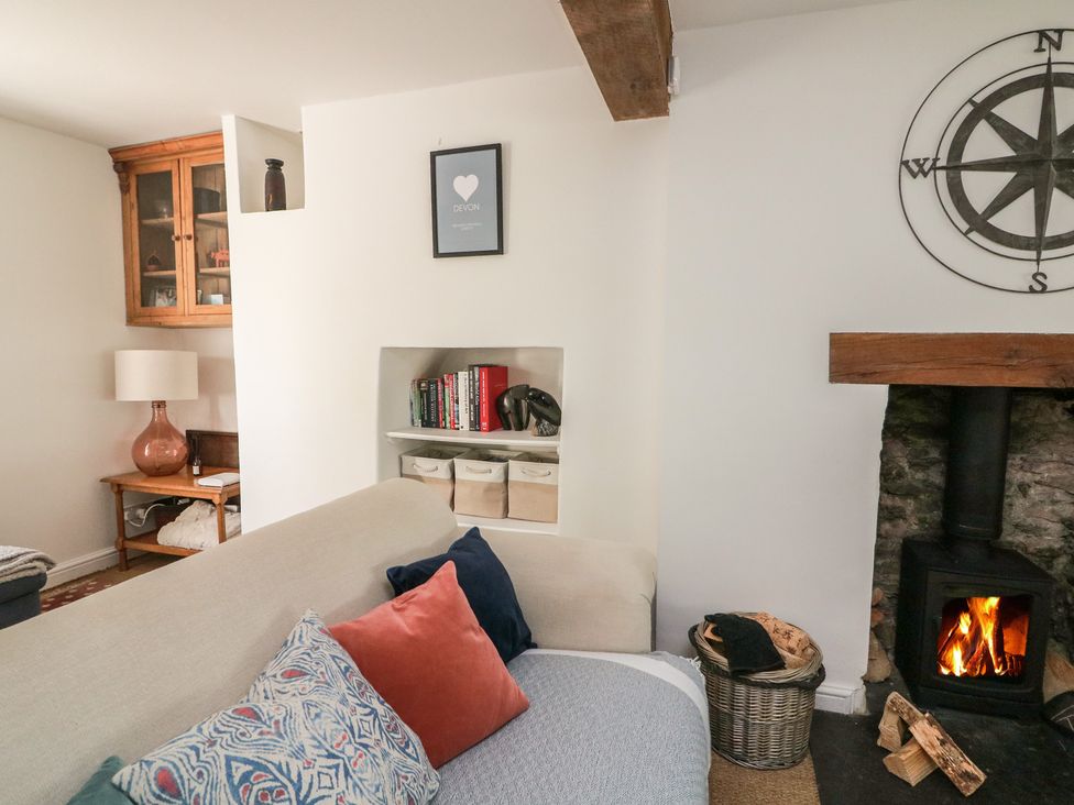 A living room with a fireplace and bookshelf at 36 Crowthers Hill, Dartmouth