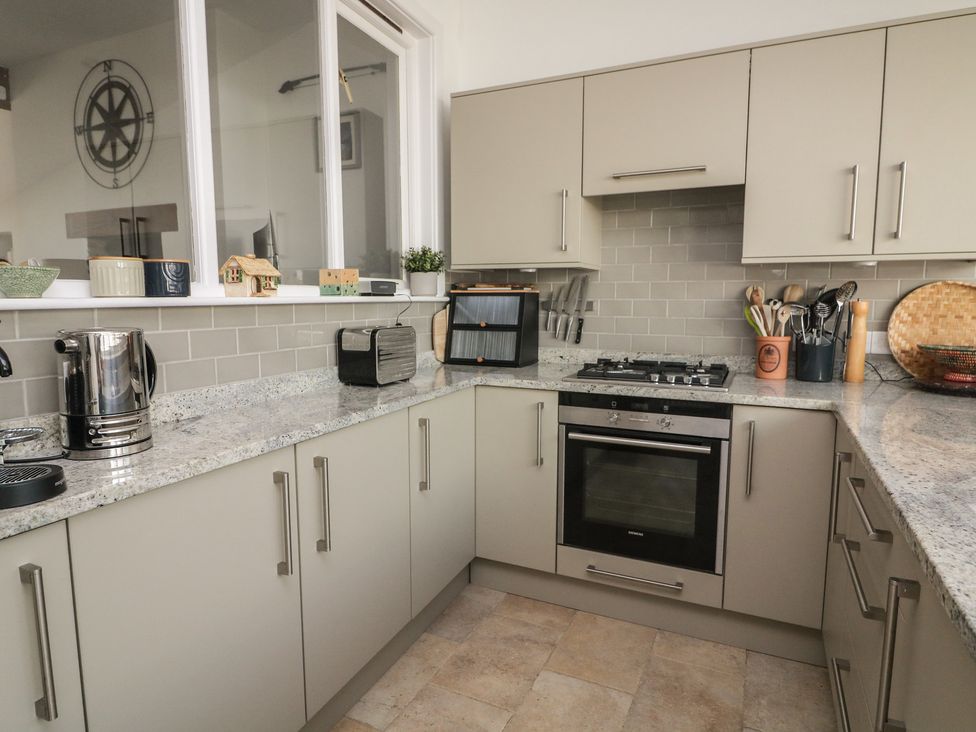 A kitchen with a gas stove and kettle at 36 Crowthers Hill in Dartmouth