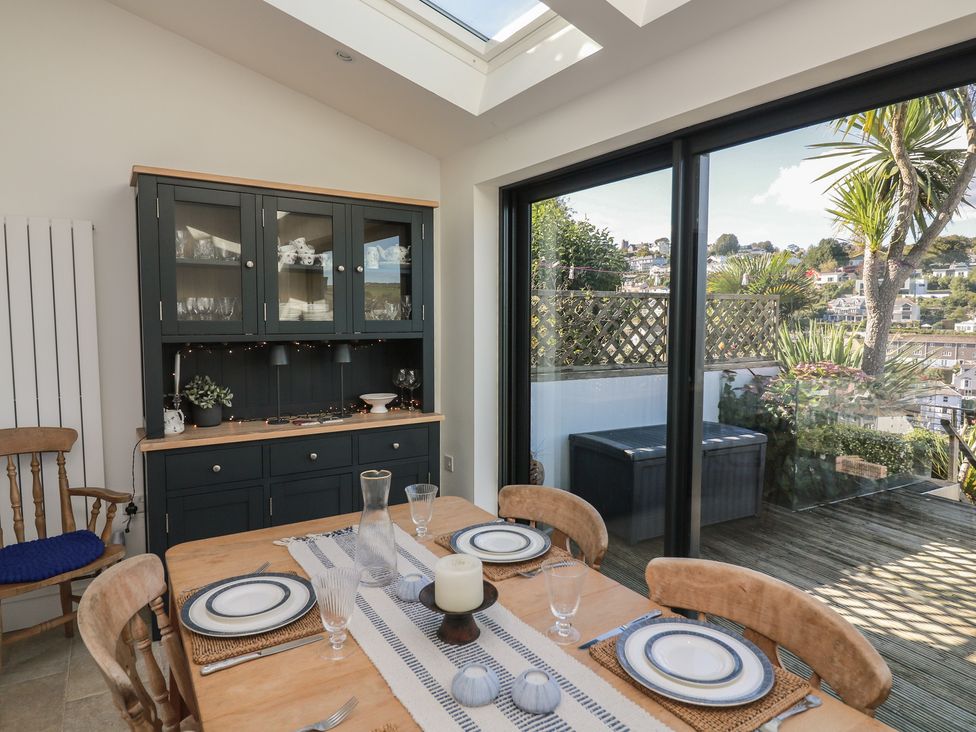 A dining room with a table set for a meal at 36 Crowthers Hill in Dartmouth
