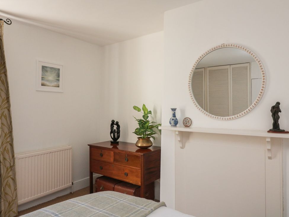 A bedroom with a dresser and mirror at 36 Crowthers Hill in Dartmouth