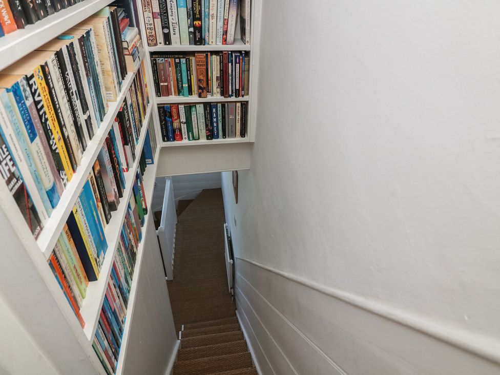 A staircase with bookshelves on the wall at 36 Crowthers Hill in Dartmouth