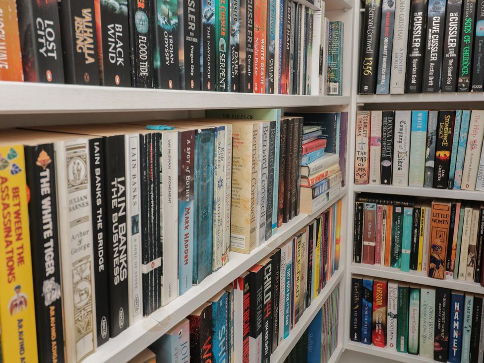 A bookshelf filled with various books at 36 Crowthers Hill in Dartmouth