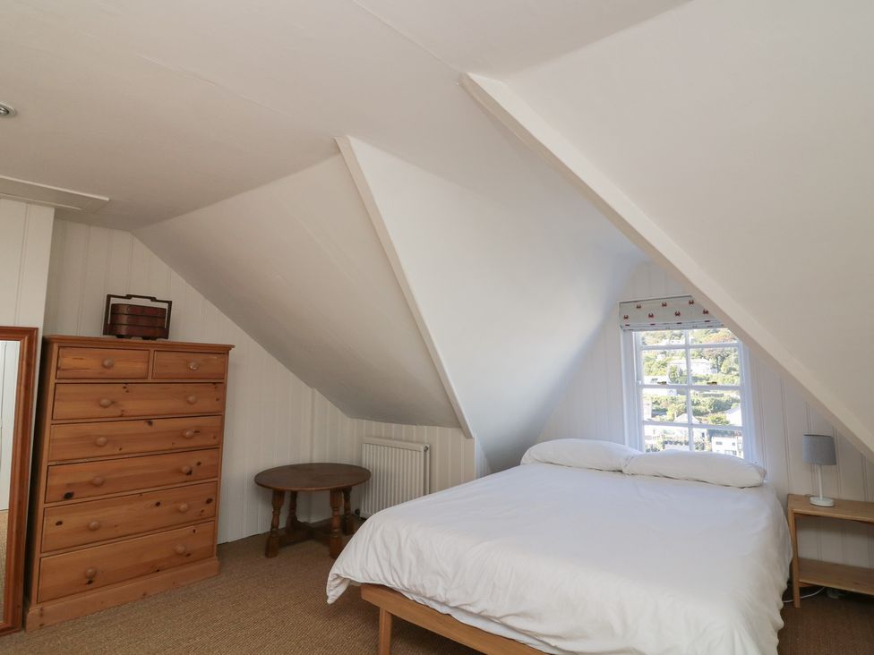 A bedroom with a bed and a chest of drawers at 36 Crowthers Hill in Dartmouth