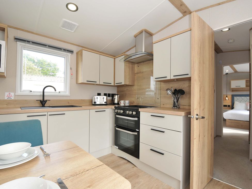 A kitchen with cabinets and appliances at Eden Way 47