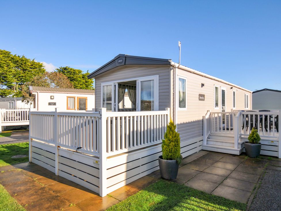 A mobile home with a deck and planter at Eden Way 47 Par