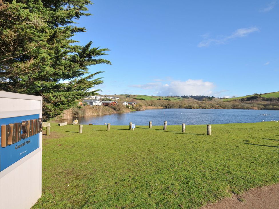A view of a lake with grass and trees at Parslands Coastal Park in Par