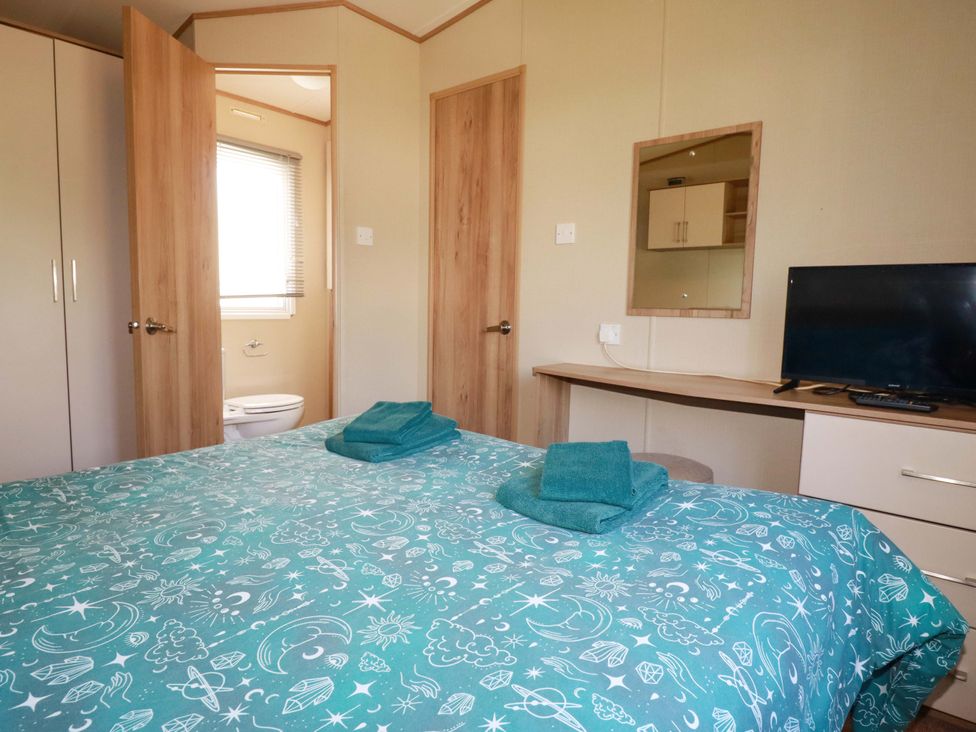 A bedroom with a bed and a television at The Oakley in Par