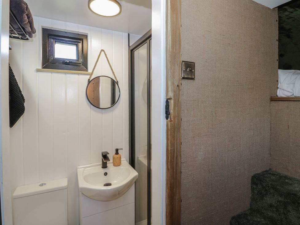 A bathroom with a sink, toilet, and shower at GiGi's Horsebox in Evesham