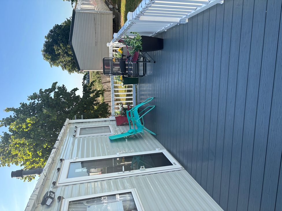An outdoor deck with chairs and a table at an unspecified location