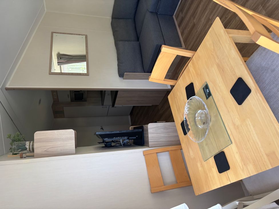 A living room with a sofa and dining table at the property location